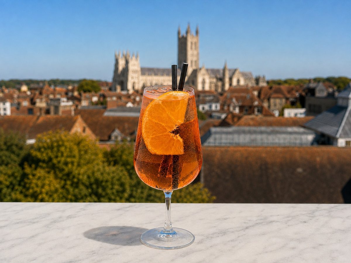 An orange spritz on the terrace wall with Canterbury Cathedral behind
